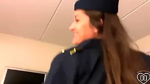 Beautiful flight attendant with large chest in hot scene with pilot-themed adult movie.